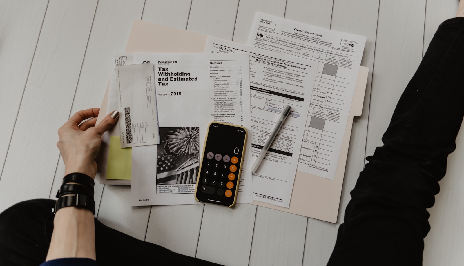 Financial documents, calculator and phone on a desk
