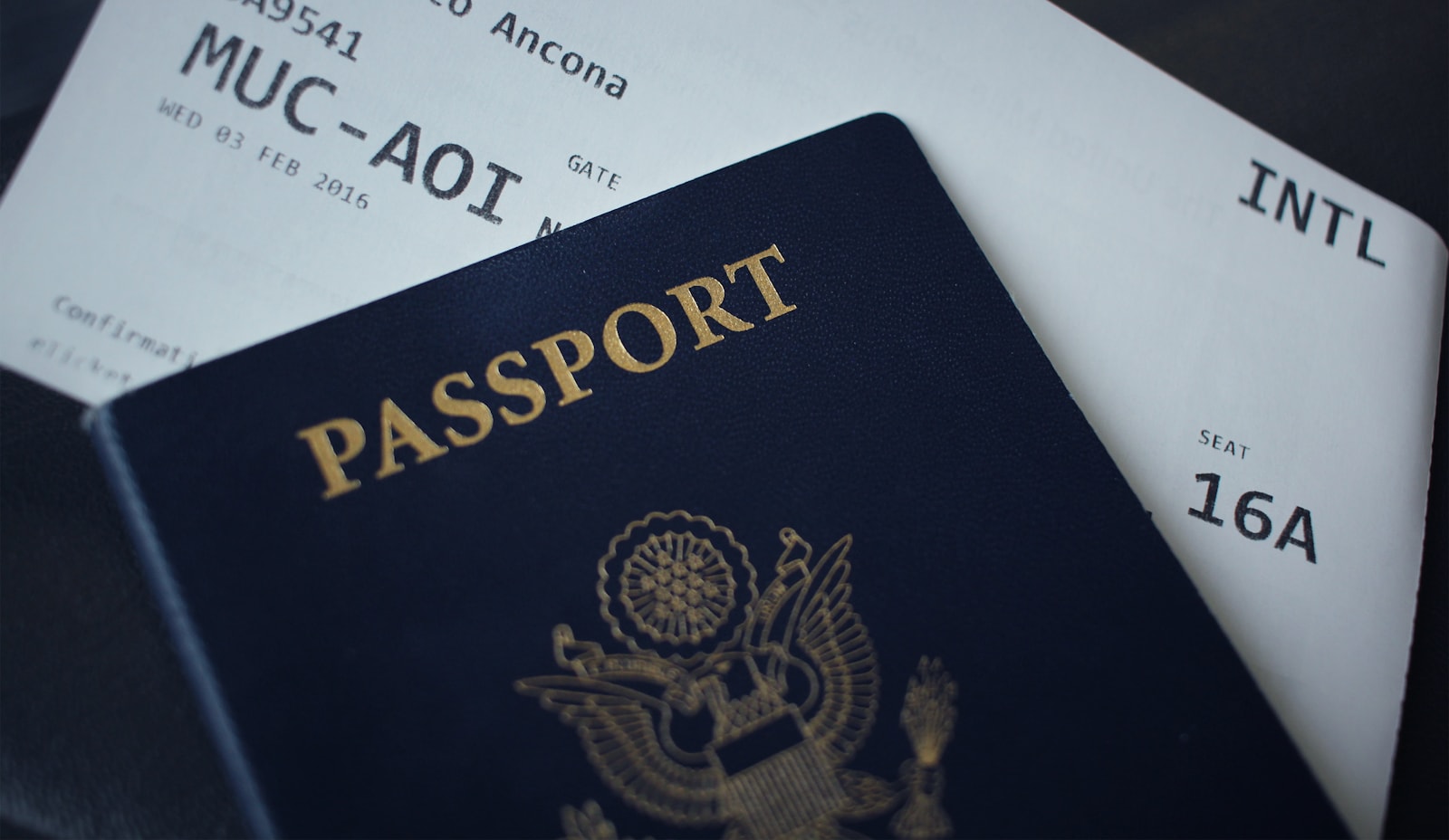 Passport and boarding pass on a desk — travel documents for a visa application