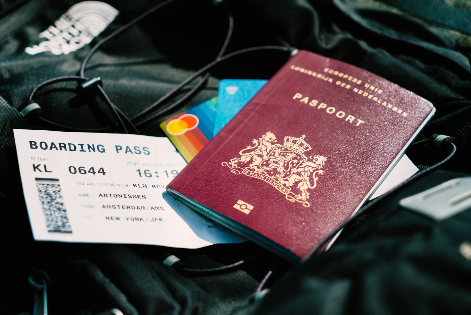 Passport, boarding pass and travel documents on a desk