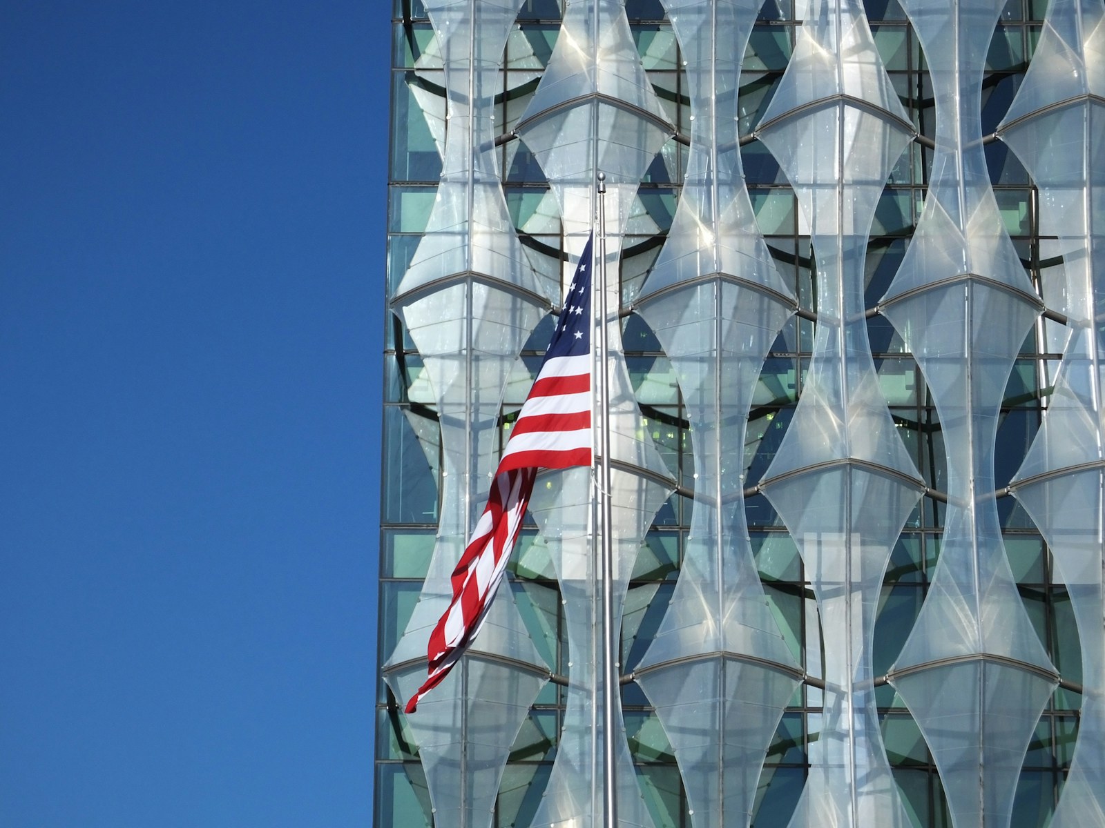 A U.S. embassy building with the American flag