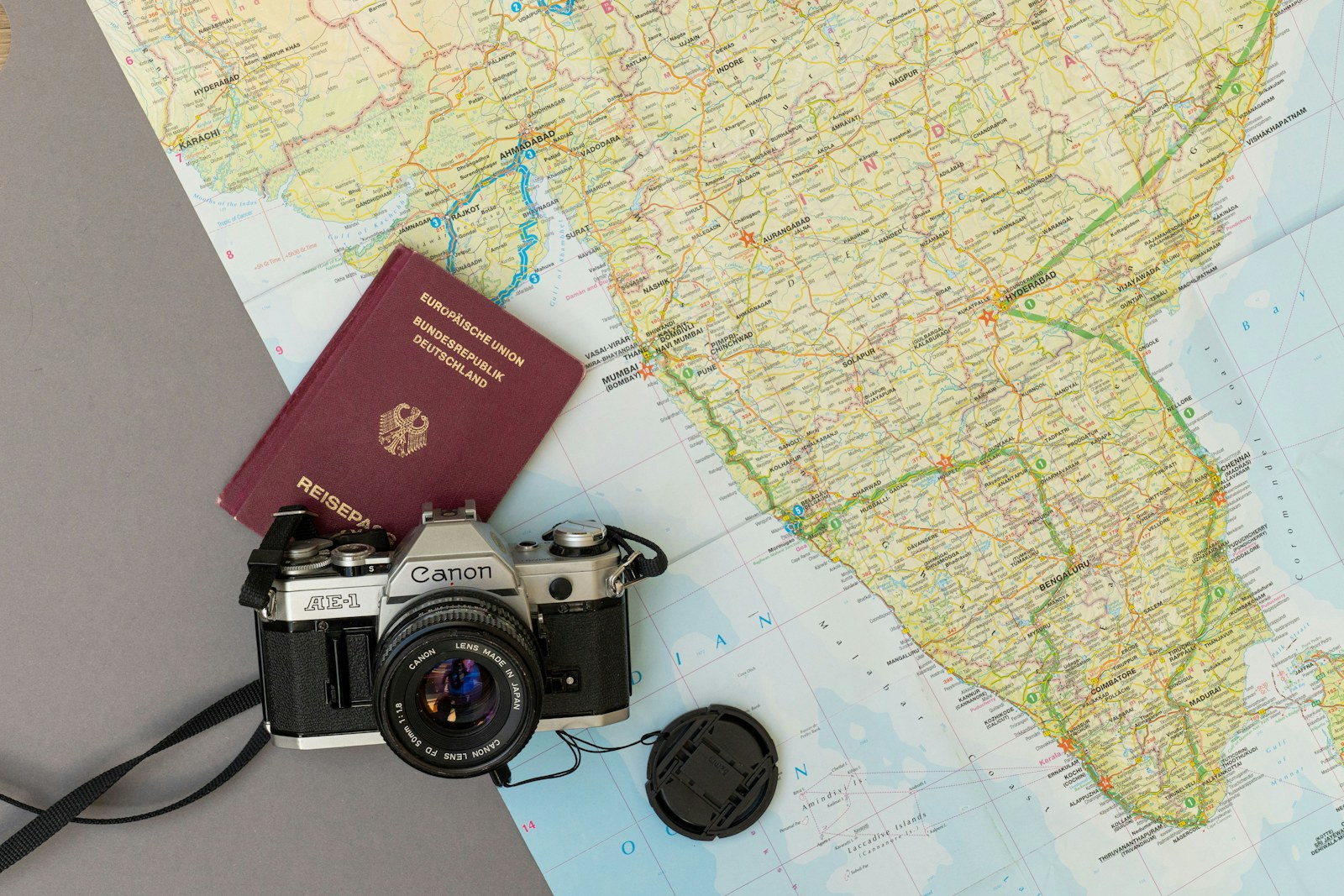 Passport on a map next to a camera — visa and travel documents
